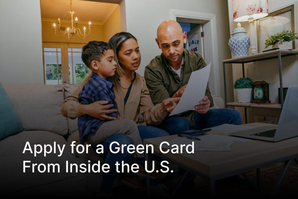 Person reviewing green card application paperwork at home for Adjustment of Status